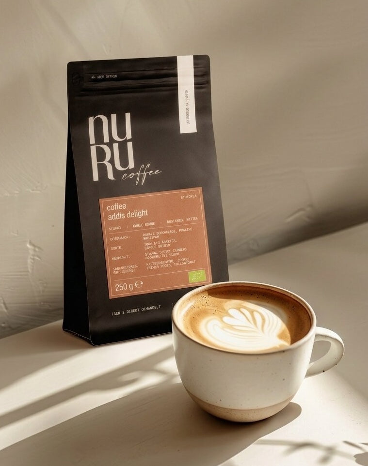 Bio Kaffee Addis Delight im zarten Sonnenlicht, Tasse mit Latte Art
